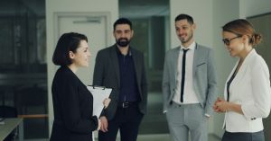 Group of professionals discussing strategy in a modern office setting.