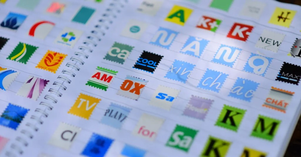 A vibrant mix of colorful stamps displayed in a spiral notebook, showcasing diverse design elements.