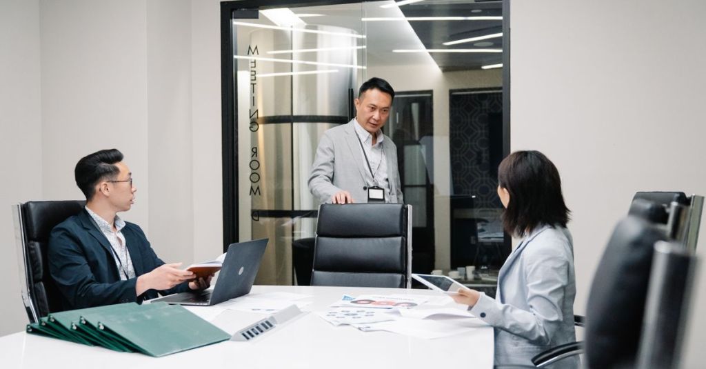 Business professionals in a meeting room engaged in teamwork and strategic planning.