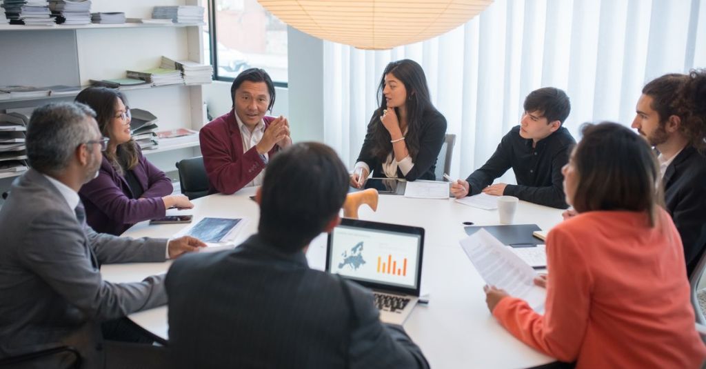 A diverse group of professionals collaborating in a modern conference room.