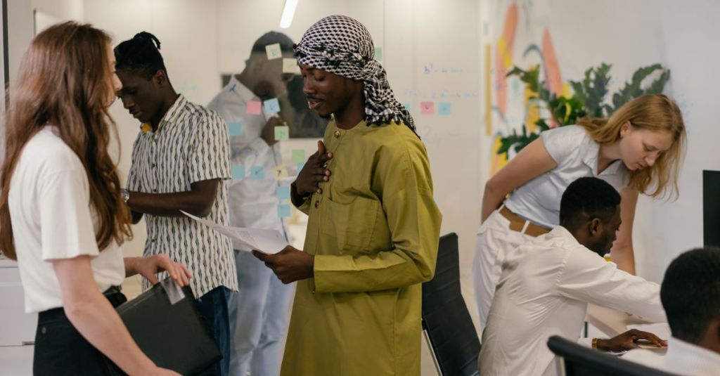 Diverse team engaged in discussion and collaboration in a modern office setting, showcasing teamwork and diversity.